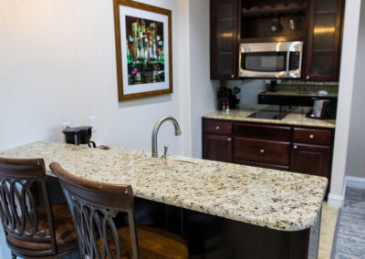 Kitchenette with bar seating for two in room at Camden on the Lake Resort