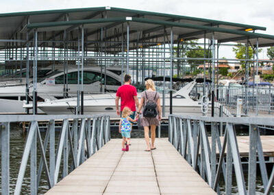 A family with young child walking on the dock at Camden on the Lake
